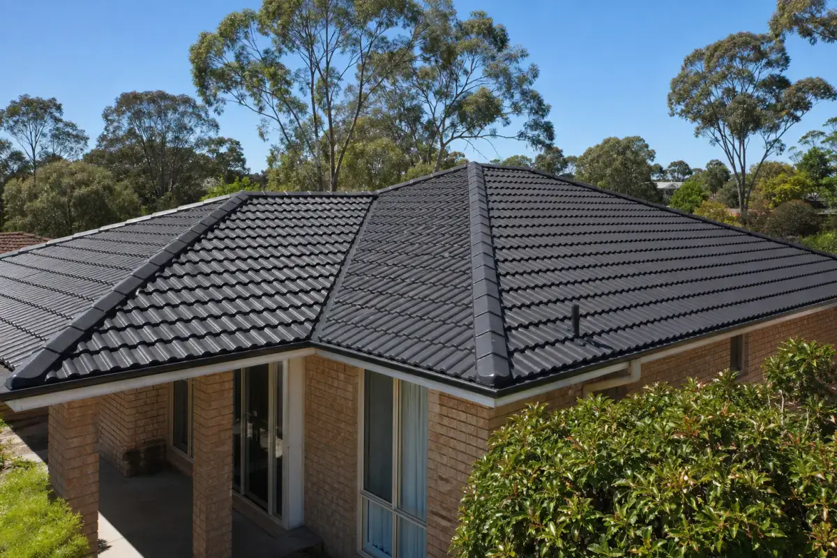 Concrete tile roof restored and recoated in deep charcoal โ Roof Restoration Canberra